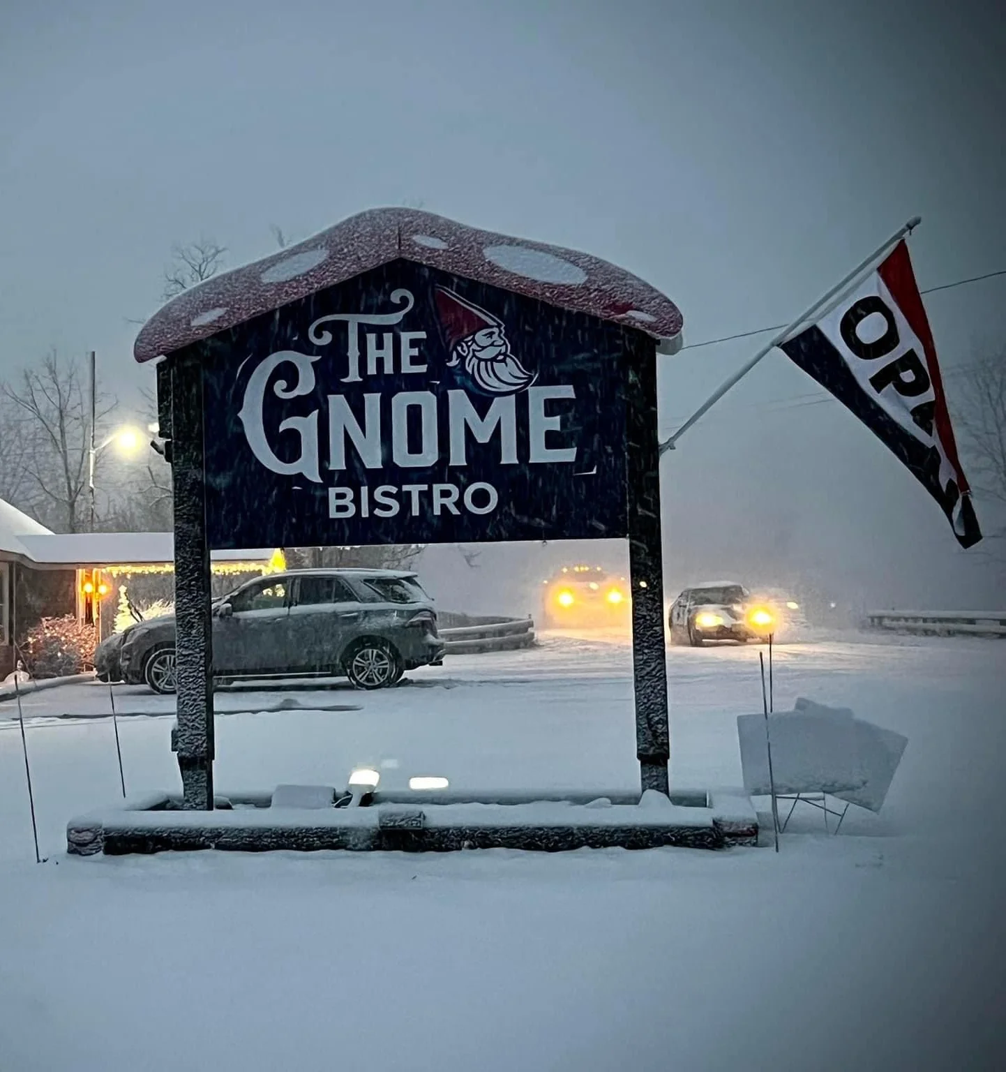 The Gnome Bistro sign in a snowy winter landscape