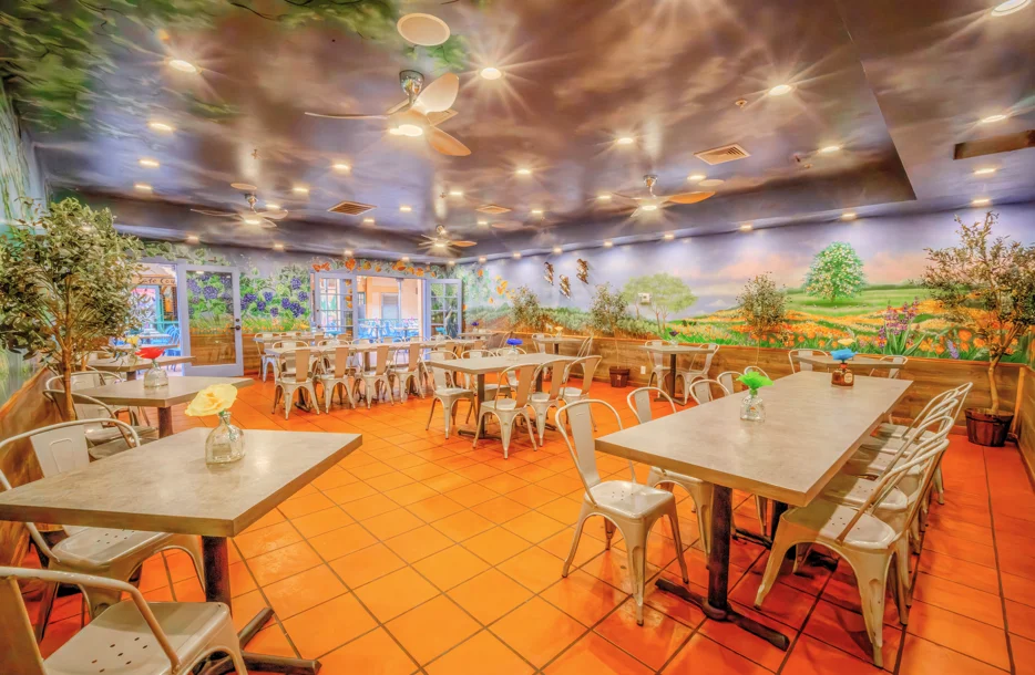 Charming restaurant interior with vibrant mural and cozy seating