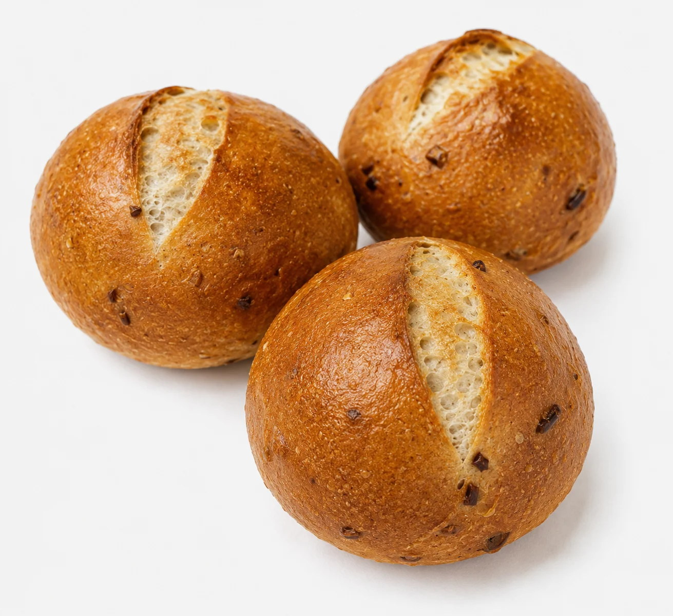 Three freshly baked round bread rolls with a golden crust.