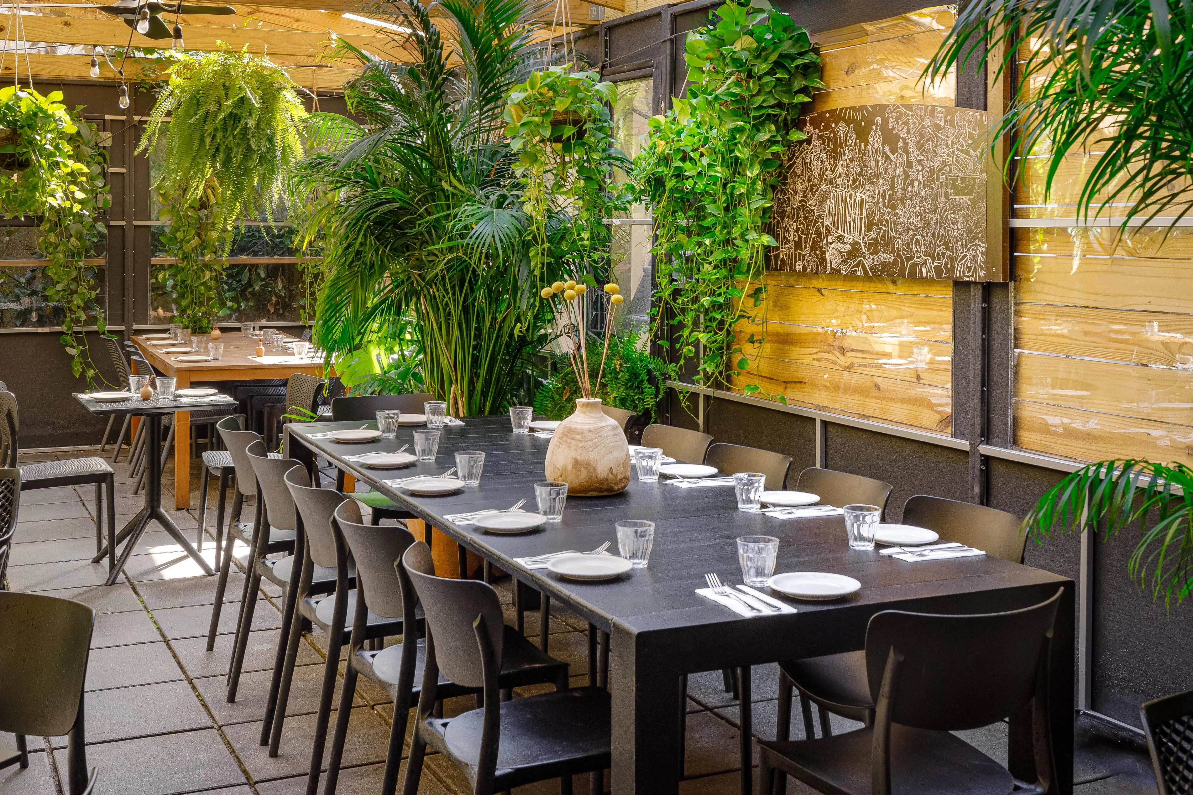 Stylish restaurant interior with greenery and communal dining table