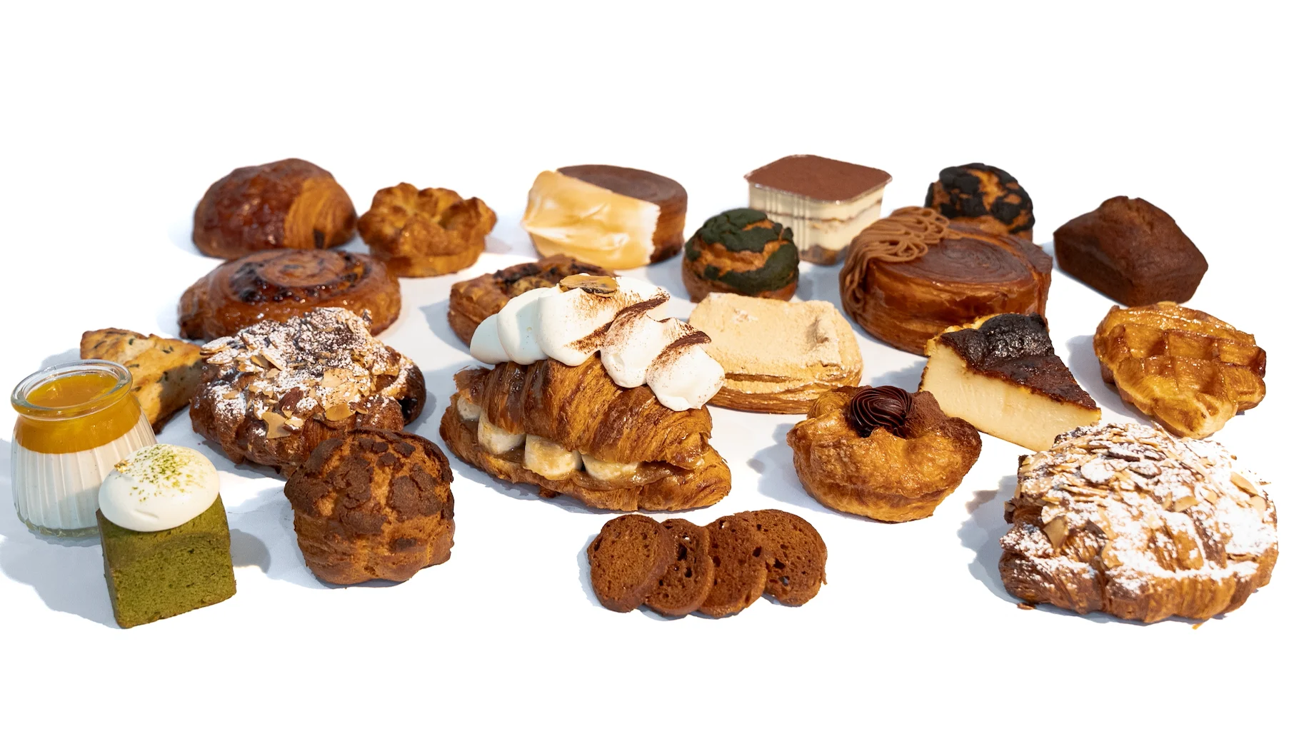 Assorted French pastries and desserts on a white background