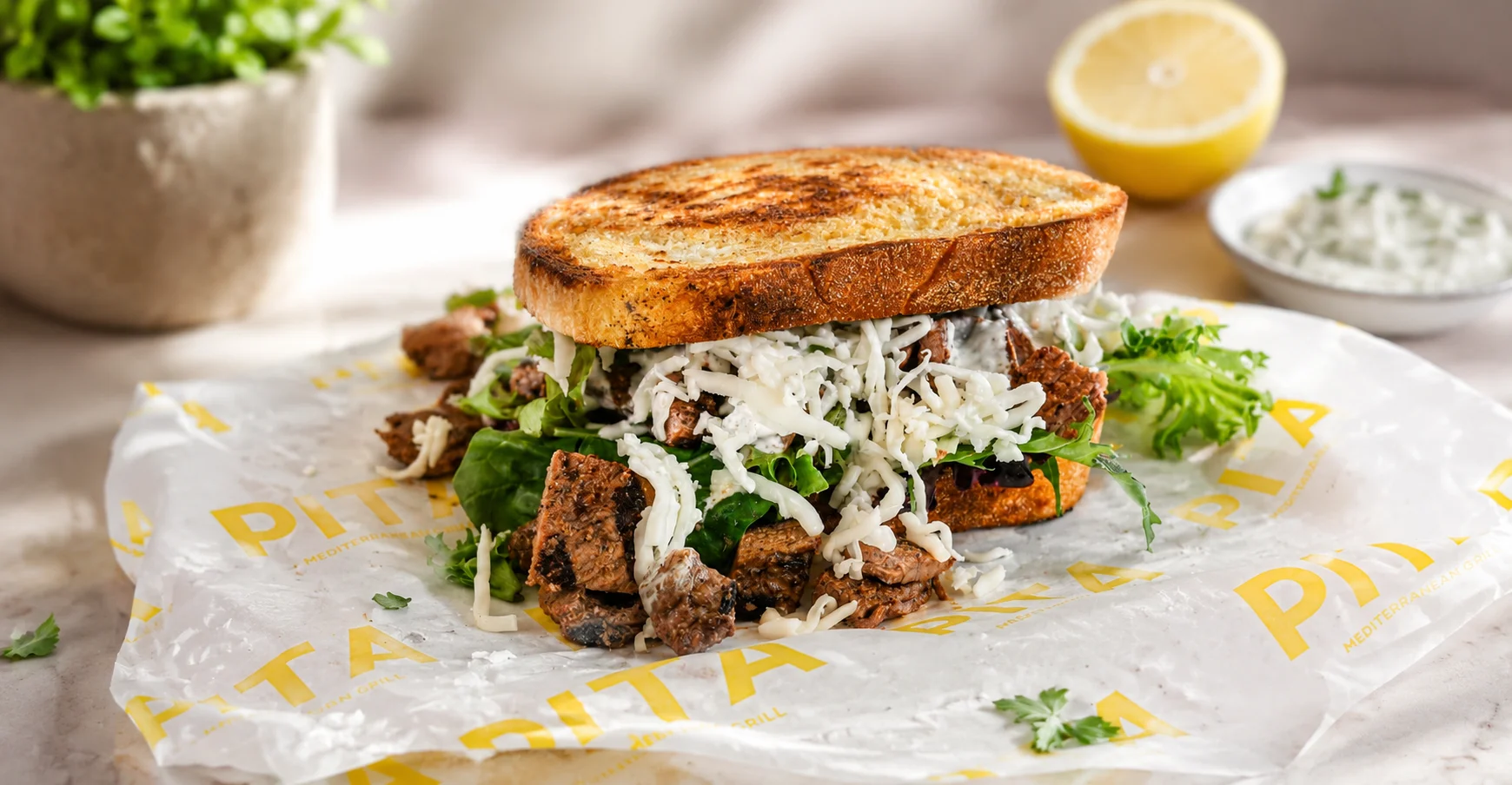 Mediterranean beef pita sandwich with fresh greens