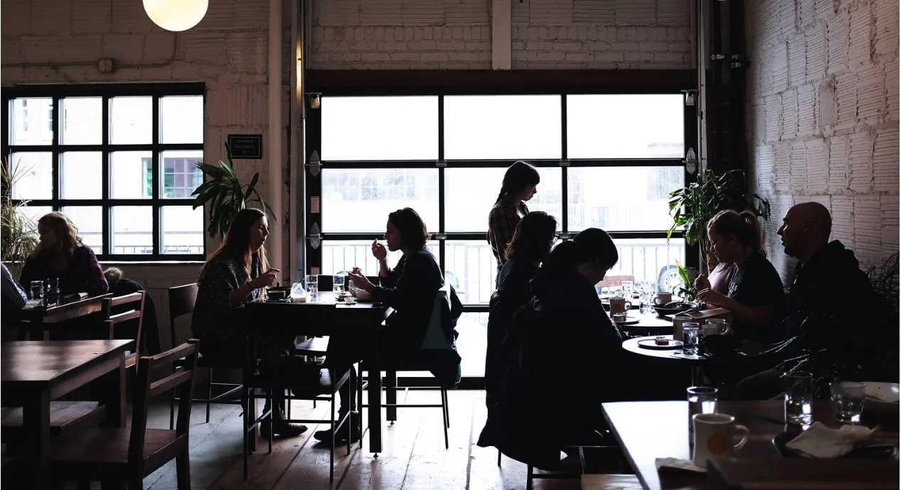Cozy restaurant interior with diners enjoying meals and natural light