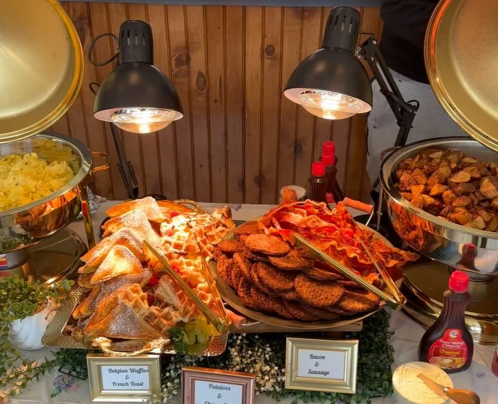 Brunch buffet featuring Belgian waffles and breakfast meats