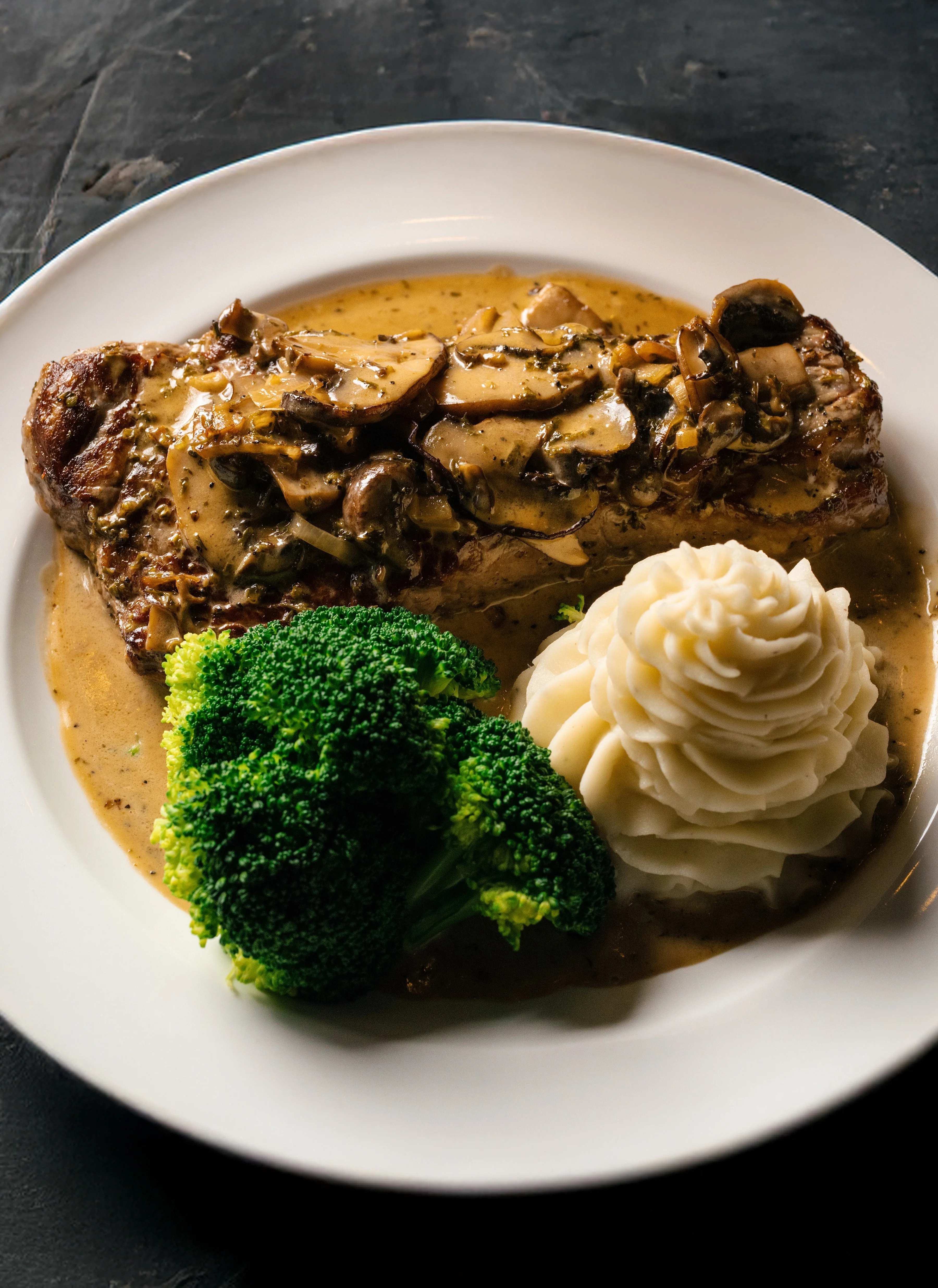 Classic American beef steak with mushroom sauce and sides