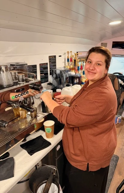 Barista preparing coffee at a cozy café