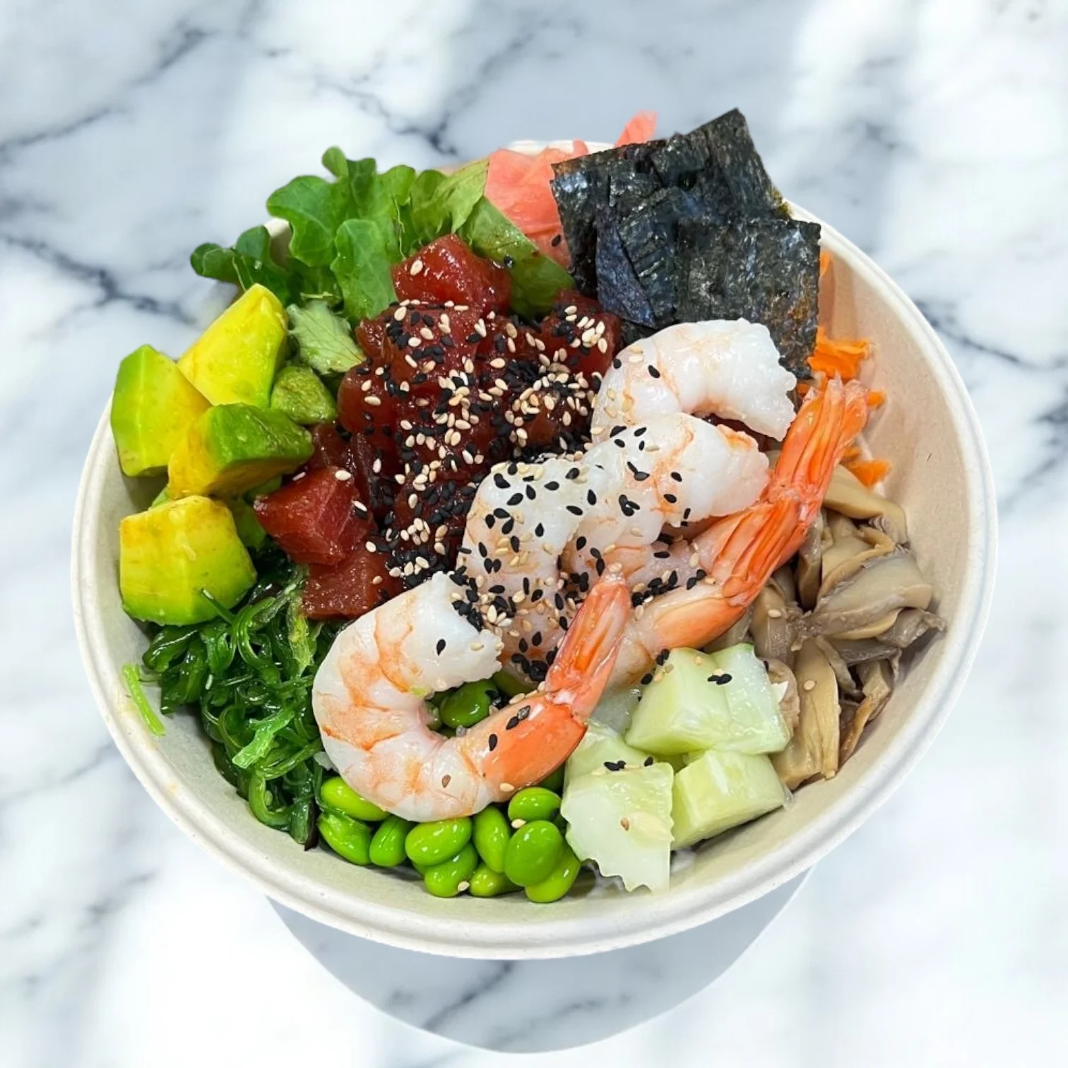 Colorful poke bowl with shrimp and fresh vegetables