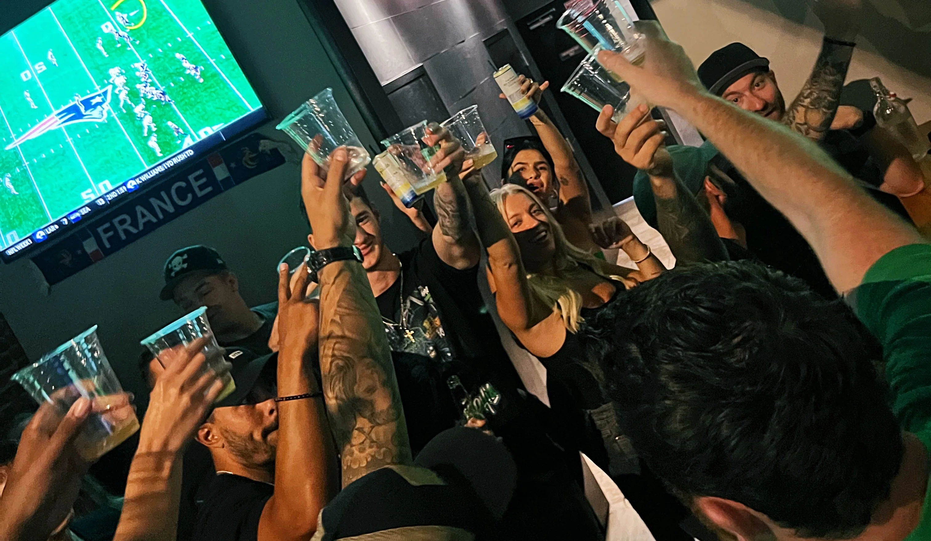 Group doing a cheers during football watch party at Giovani's Bar and Grill