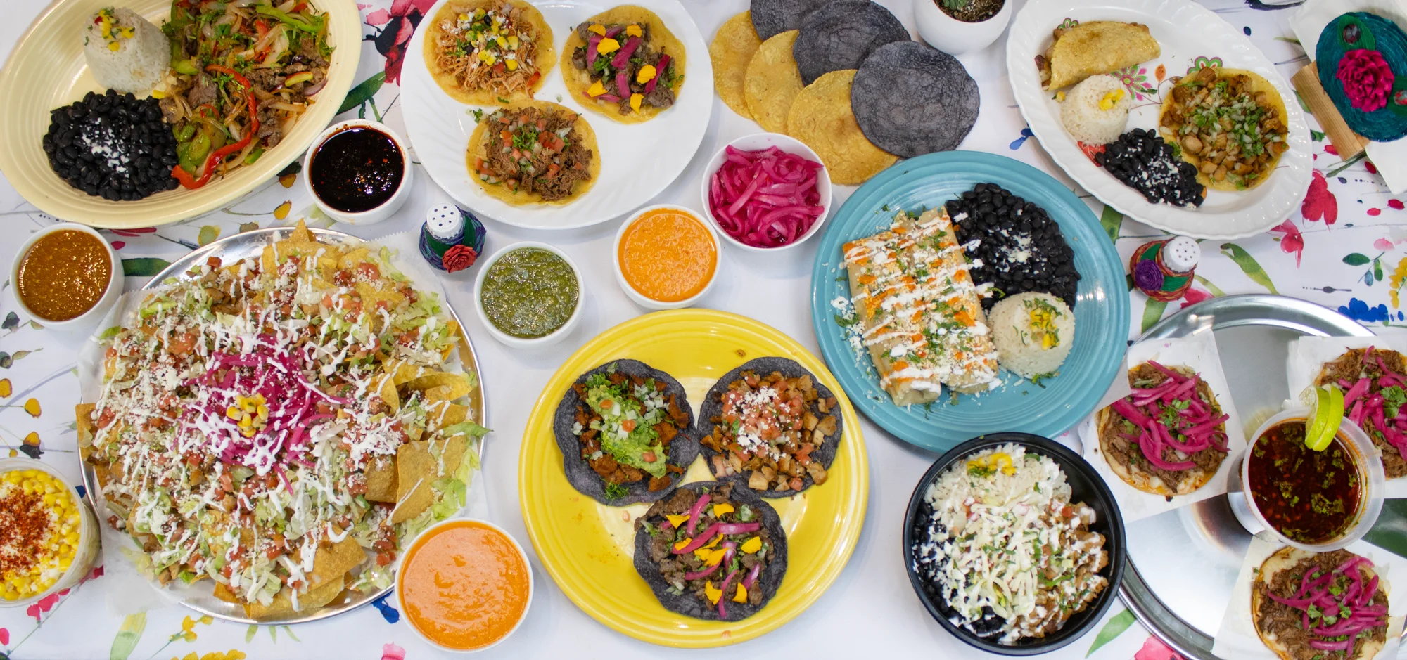 Colorful Mexican feast with tacos, nachos, and enchiladas