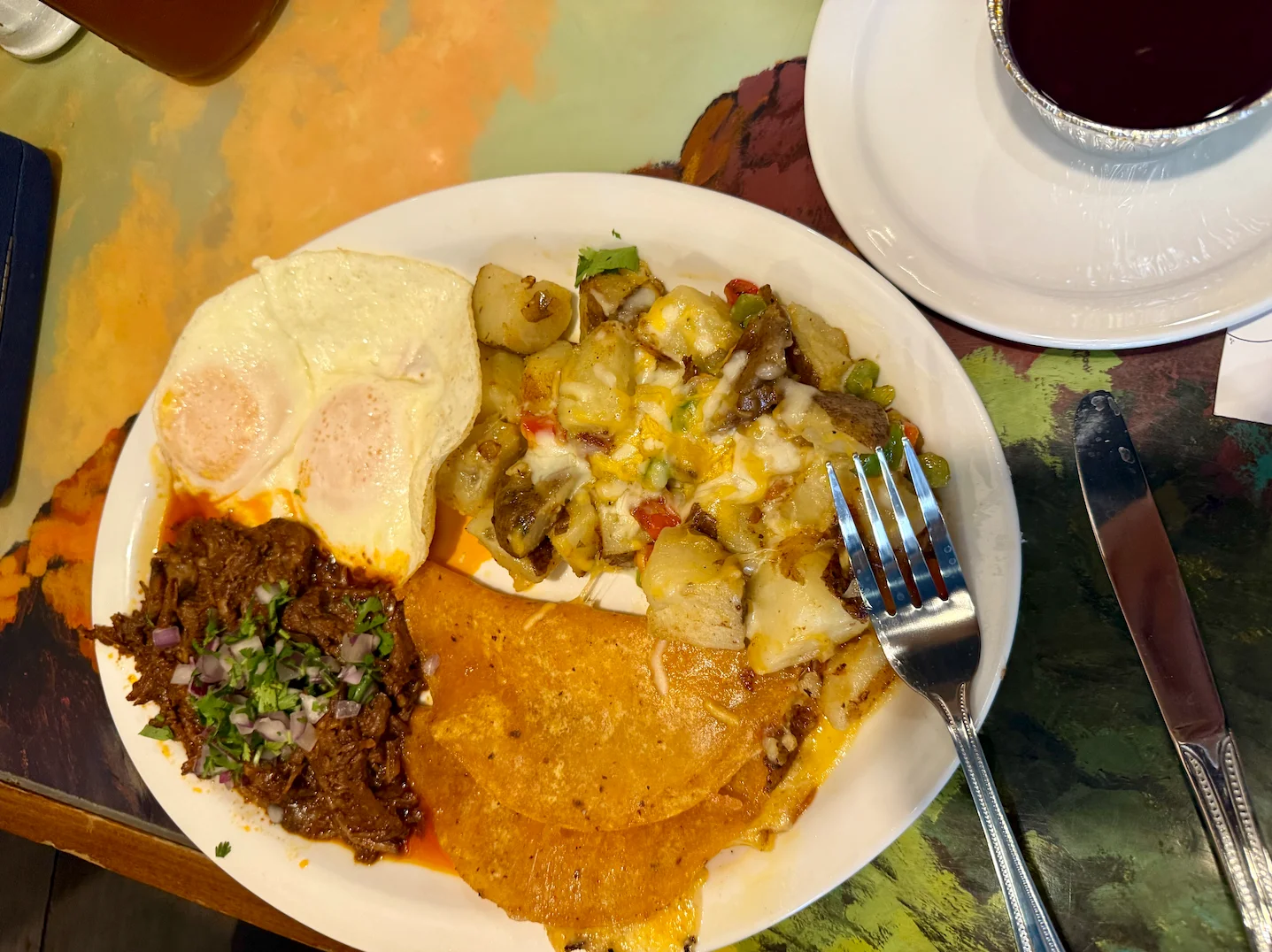 Traditional Mexican breakfast plate with eggs, beef, and potatoes
