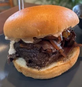 Savory pulled beef sandwich with caramelized onions