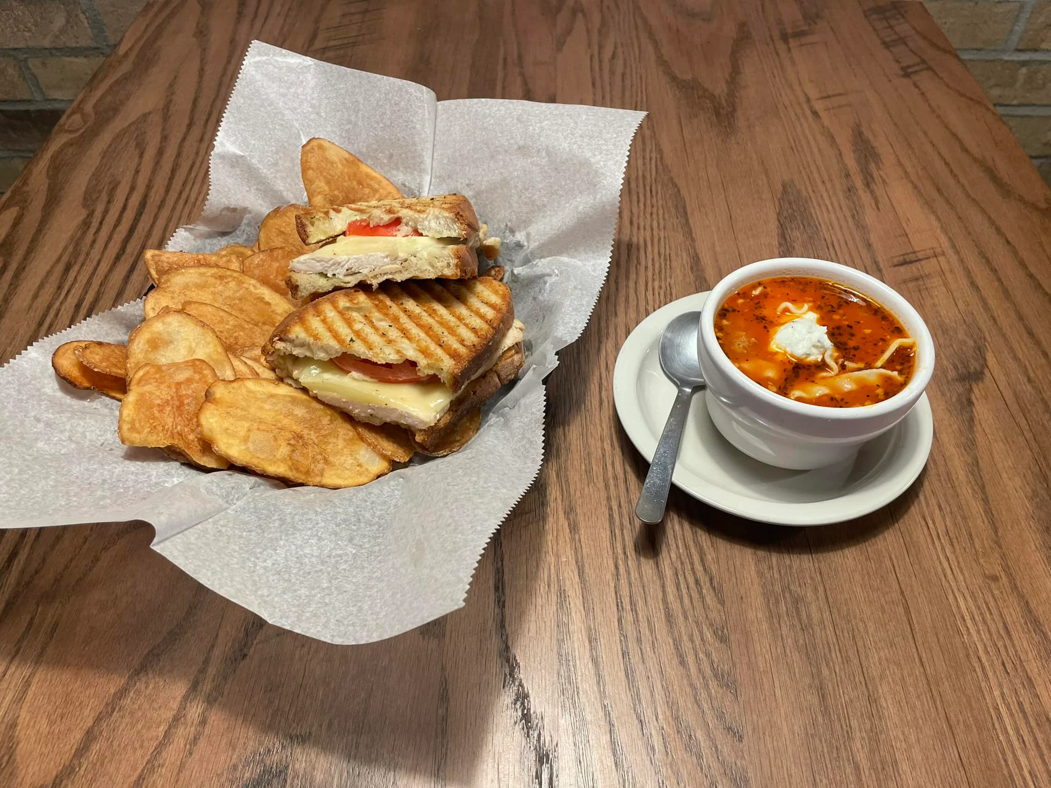Grilled cheese sandwich with soup in a cozy diner setting