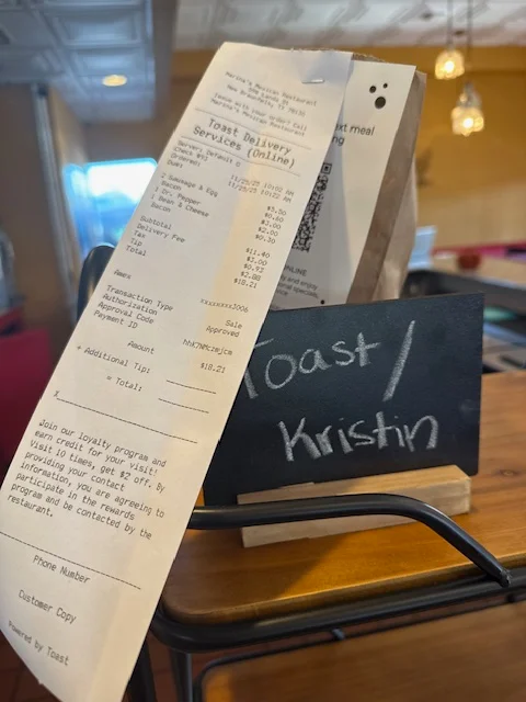 Receipt from Toast Delivery Services at a cozy restaurant
