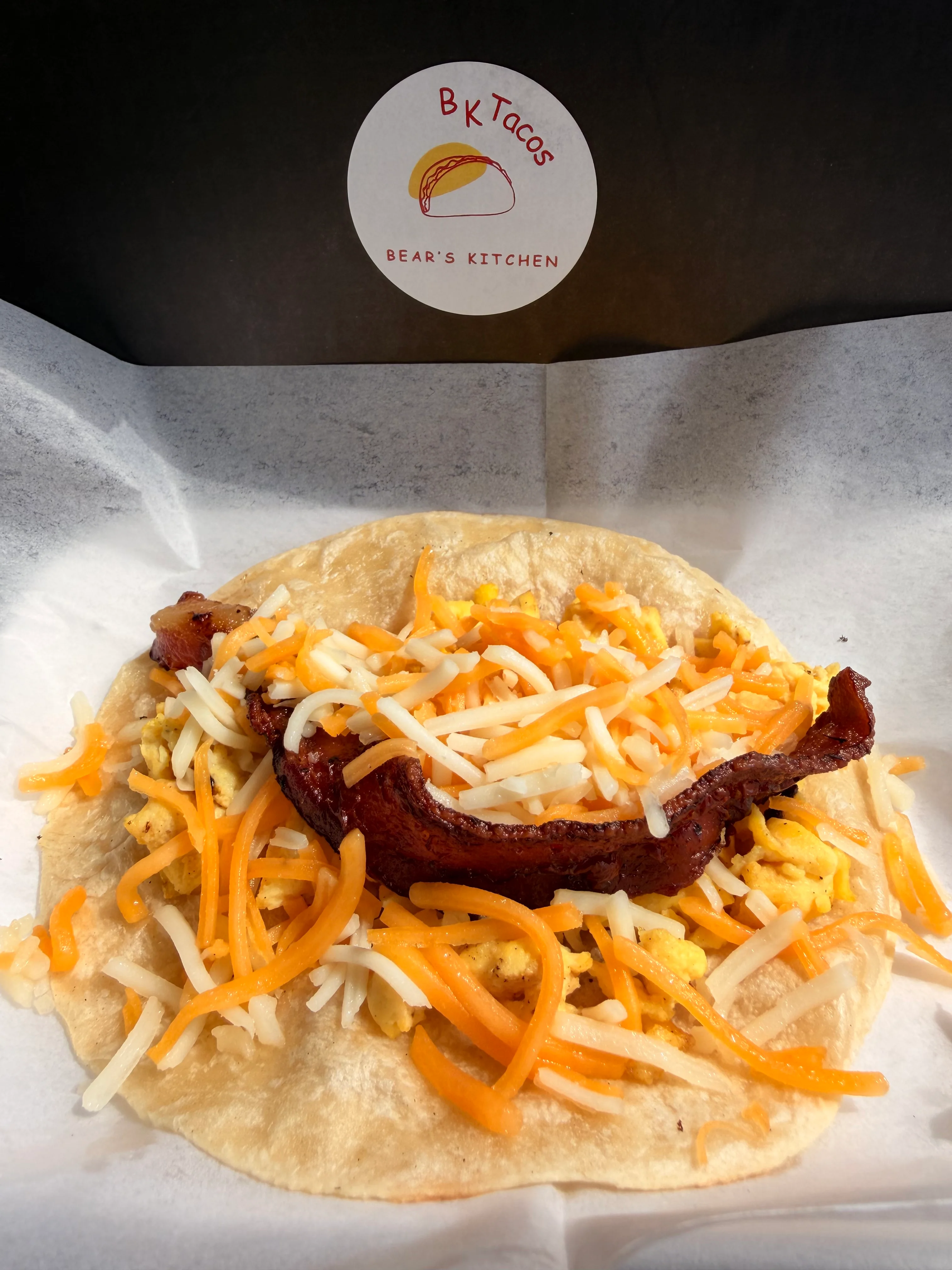 Delicious breakfast taco with scrambled eggs and cheese