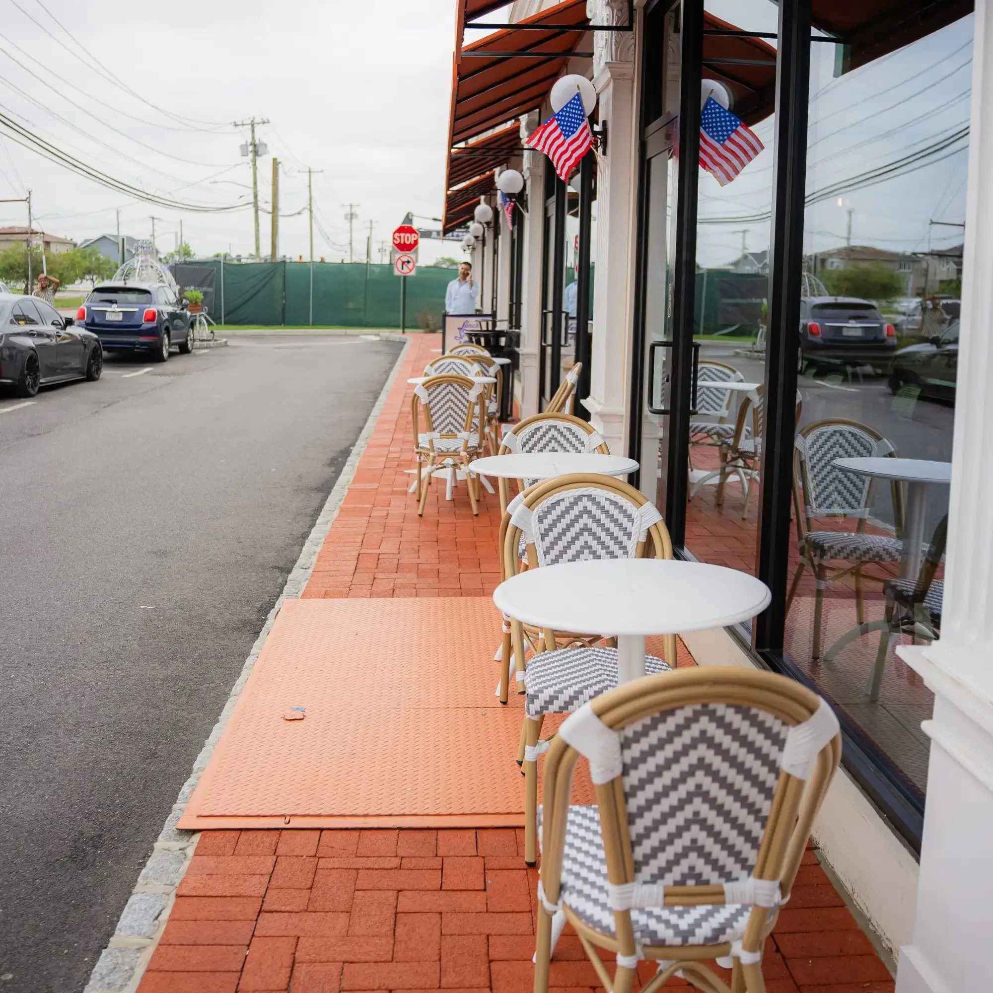 Outdoor dining area with bistro chairs and tables.