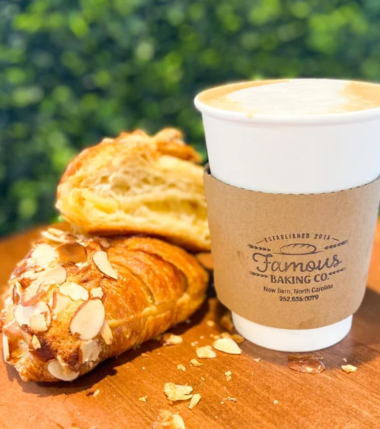 Freshly baked almond croissant with coffee