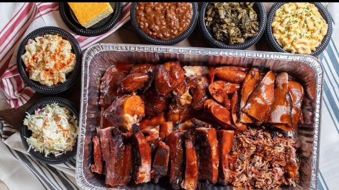 Southern barbecue platter with ribs, chicken, and sides