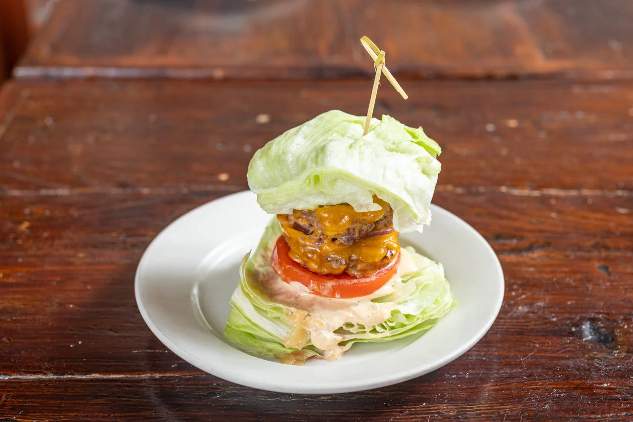 Lettuce-wrapped cheeseburger with tomato