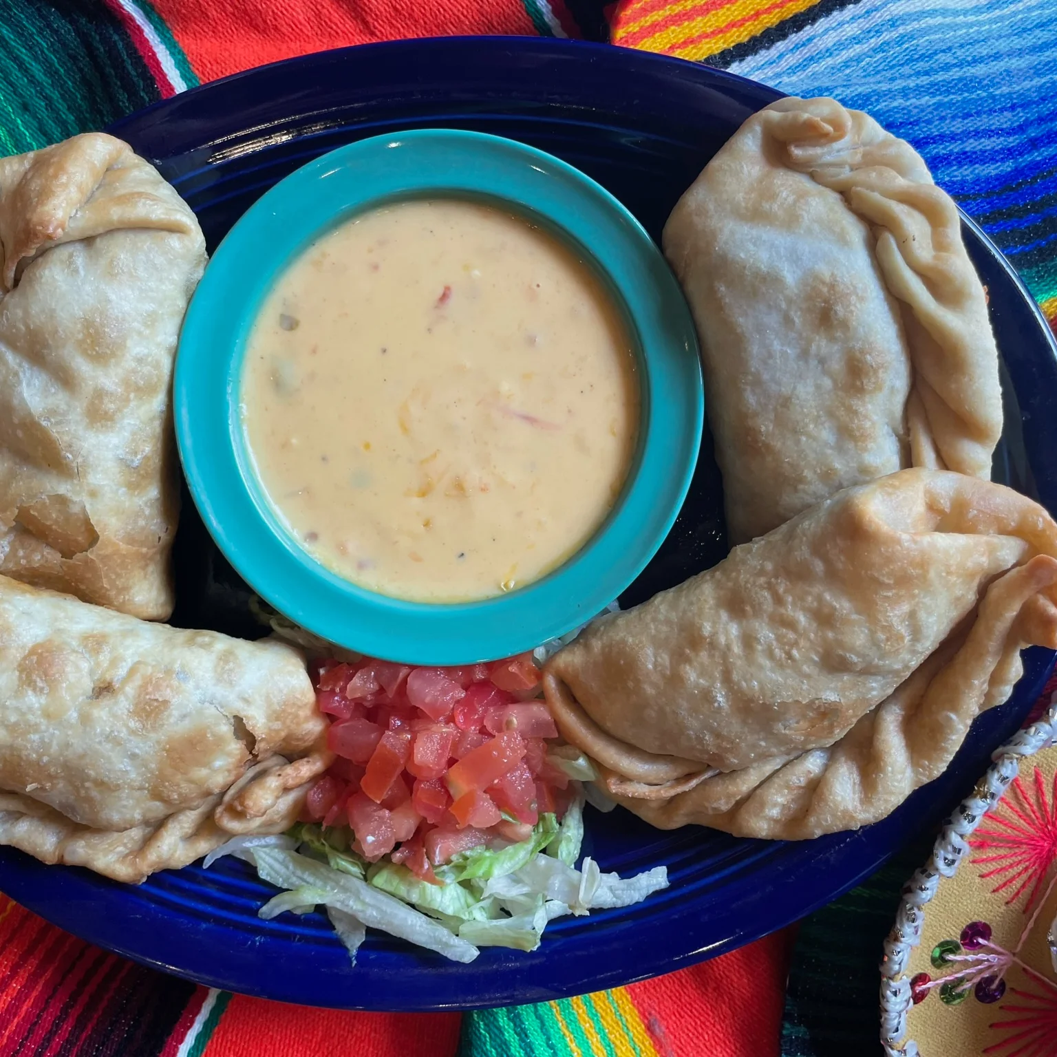 Crispy Mexican empanadas with cheese dip and fresh toppings