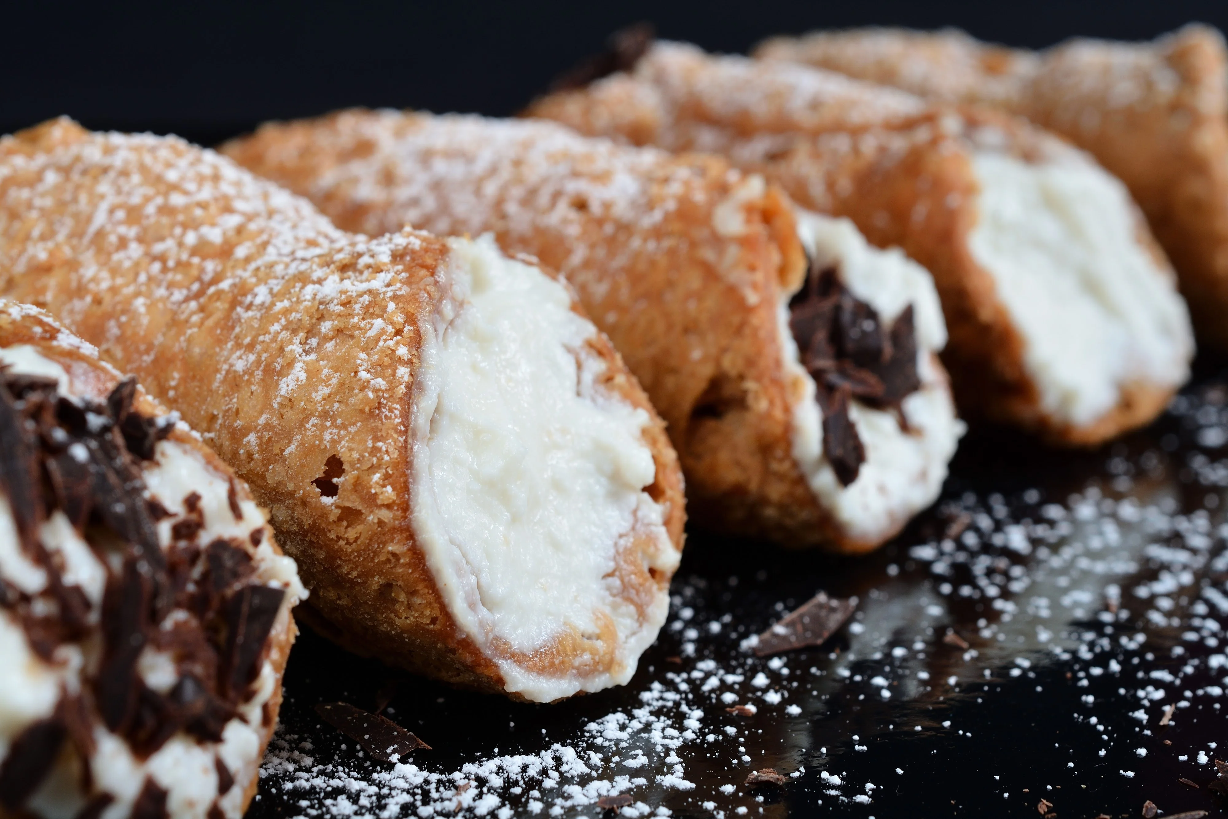Delicious Italian cannoli dusted with powdered sugar
