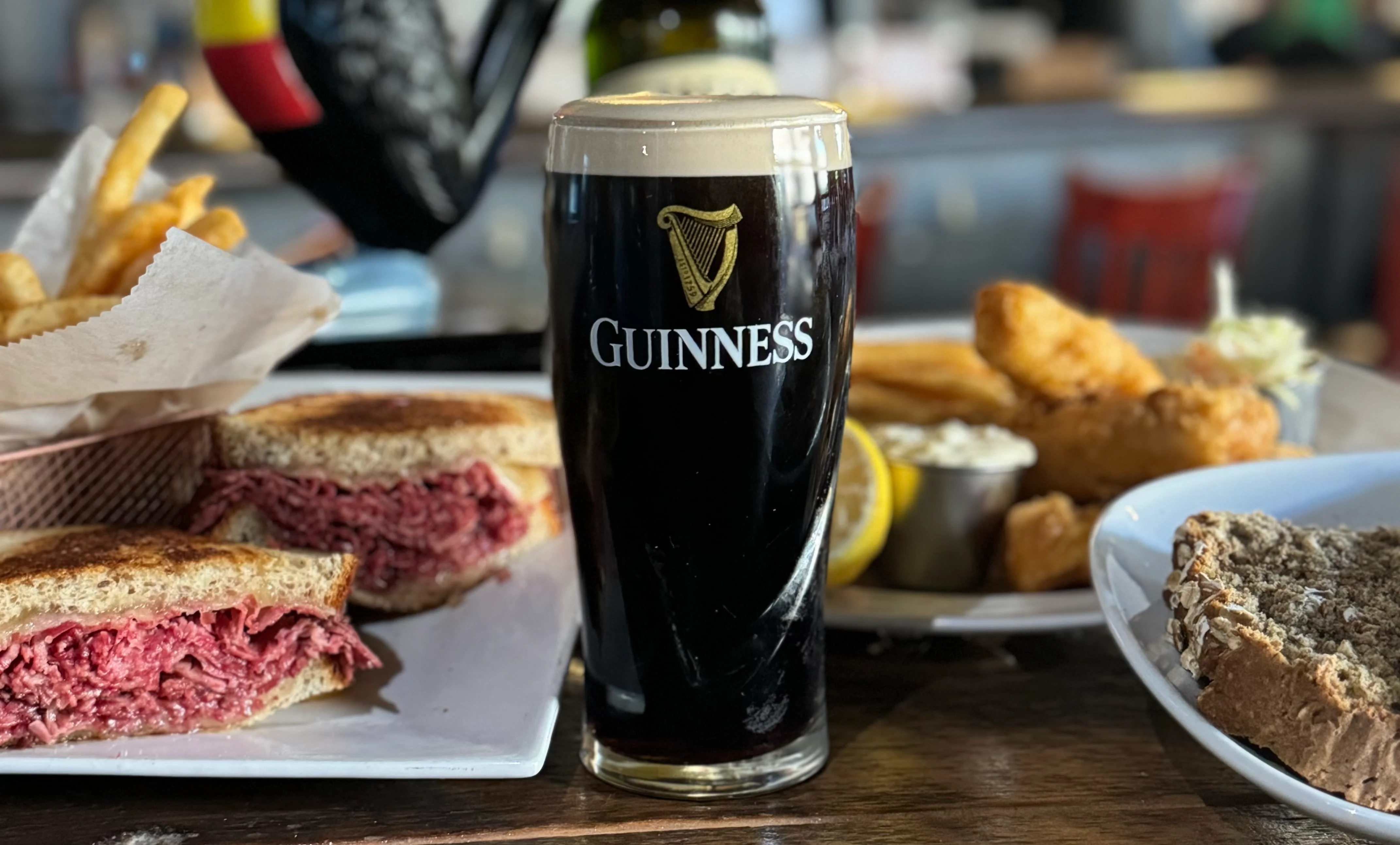 Irish pub meal with Guinness, corned beef sandwich, and fries