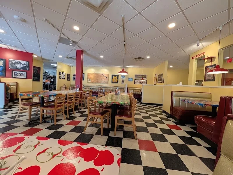 Colorful retro American diner interior with checkered floors and booths