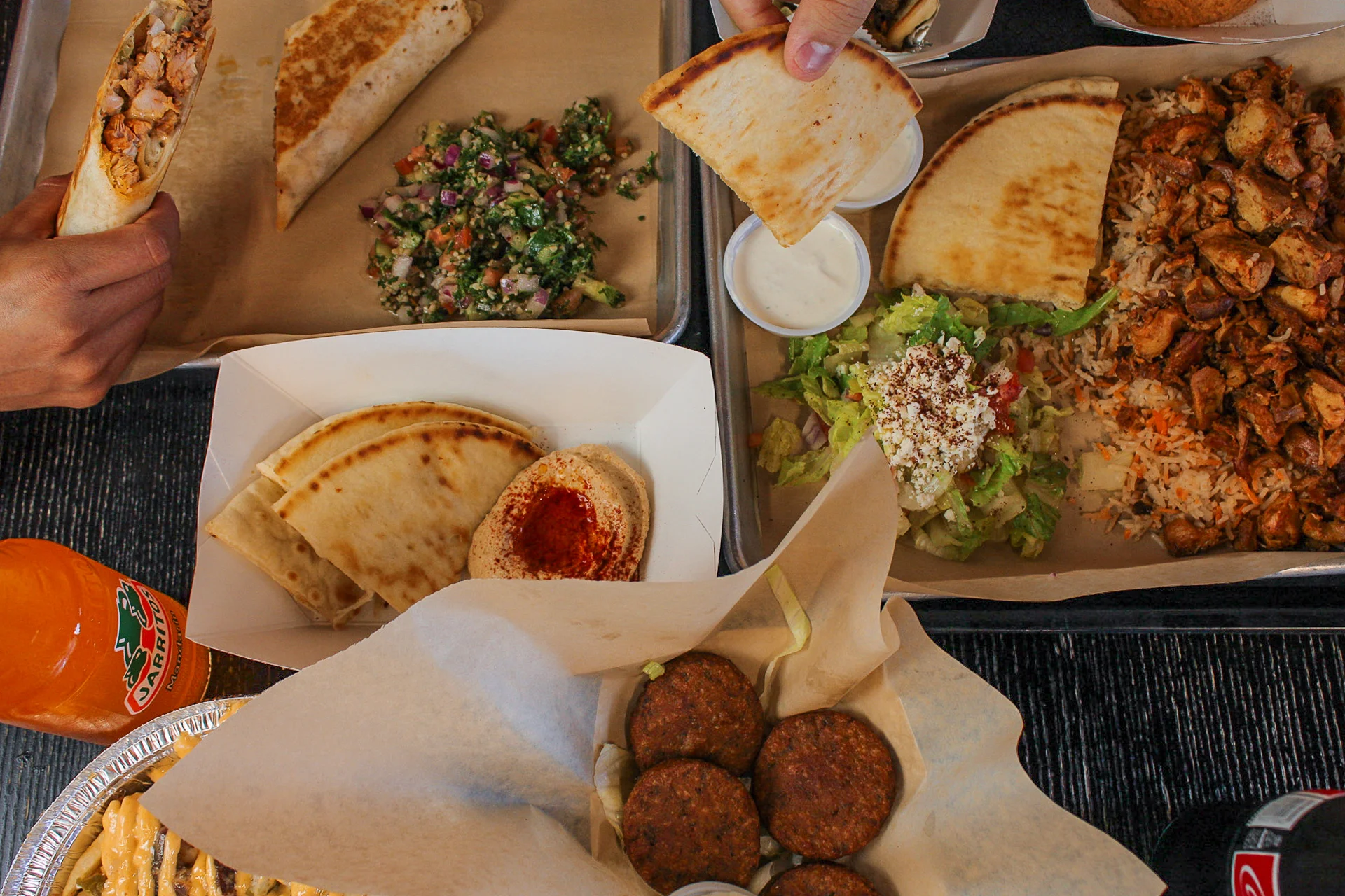 A spread of authentic Mediterranean food from Gyros by Ali