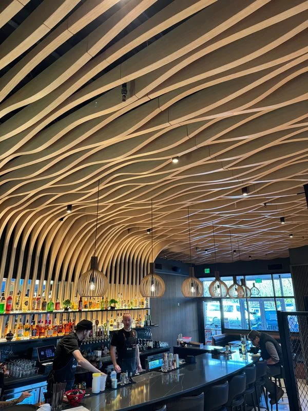 Modern bar interior with unique wooden ceiling design