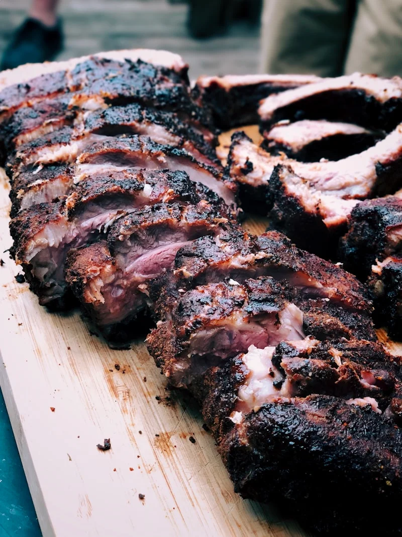 Smoked barbecue ribs sliced on a wooden board