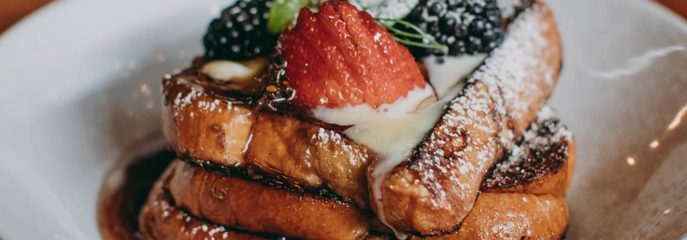 Delicious French toast topped with berries and syrup