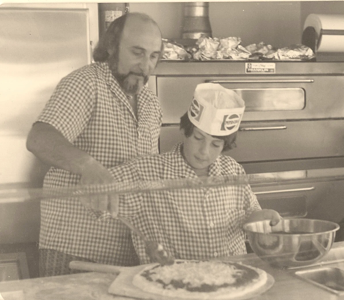Pizza preparation in a classic pizzeria kitchen