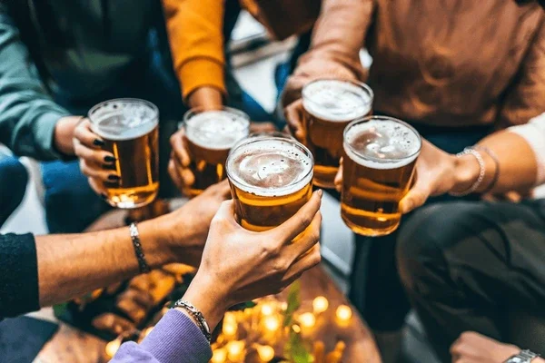 Group of friends toasting with beers in a cozy setting