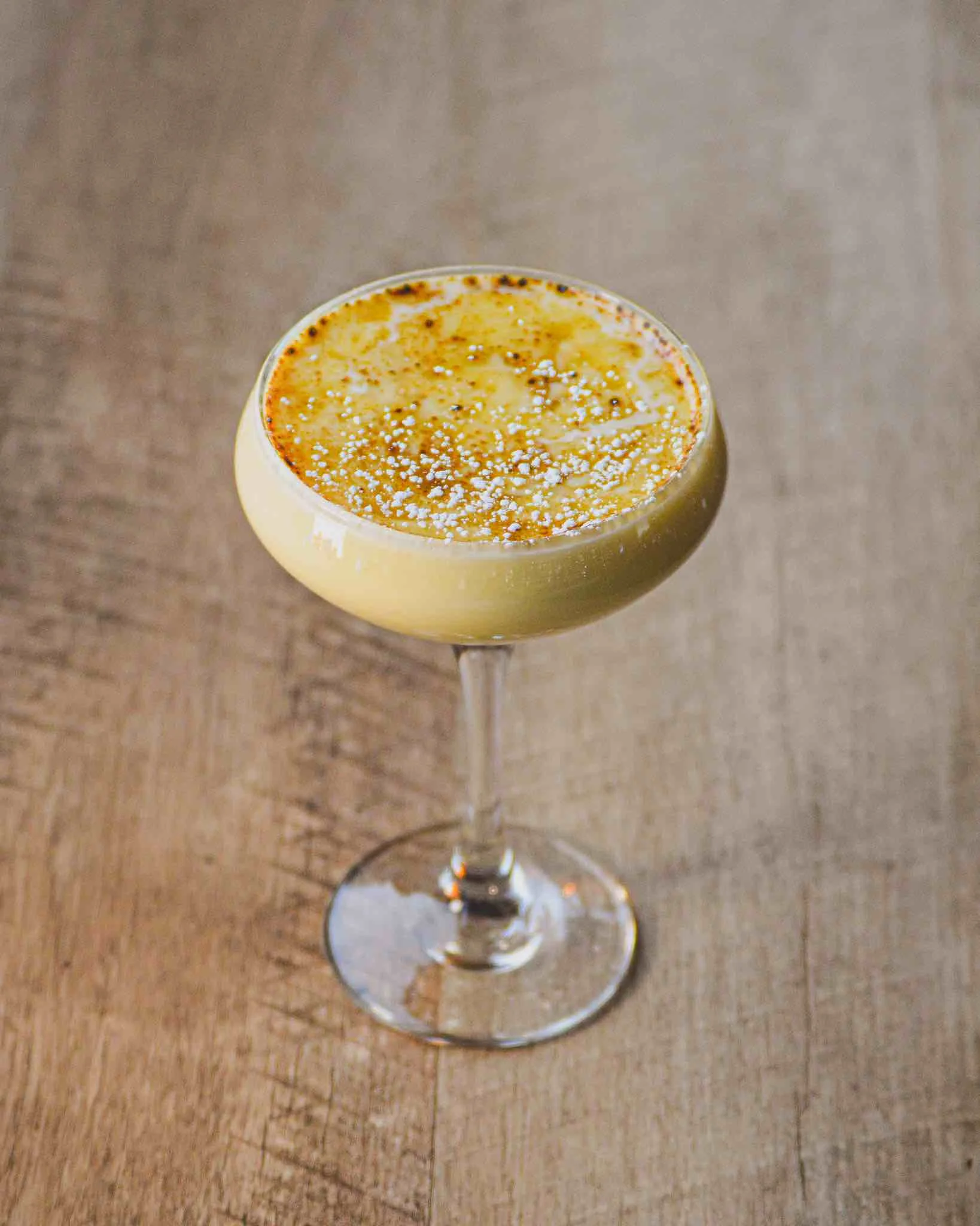 Creme Brulee Eggnog Cocktail on a wooden table