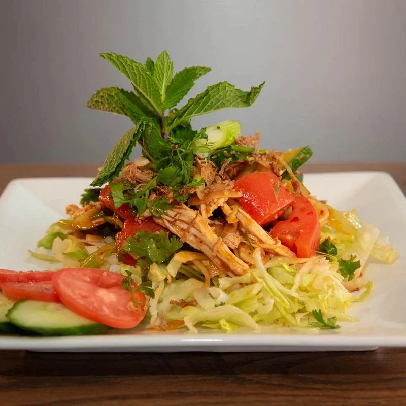 Thai chicken salad with fresh herbs and vegetables