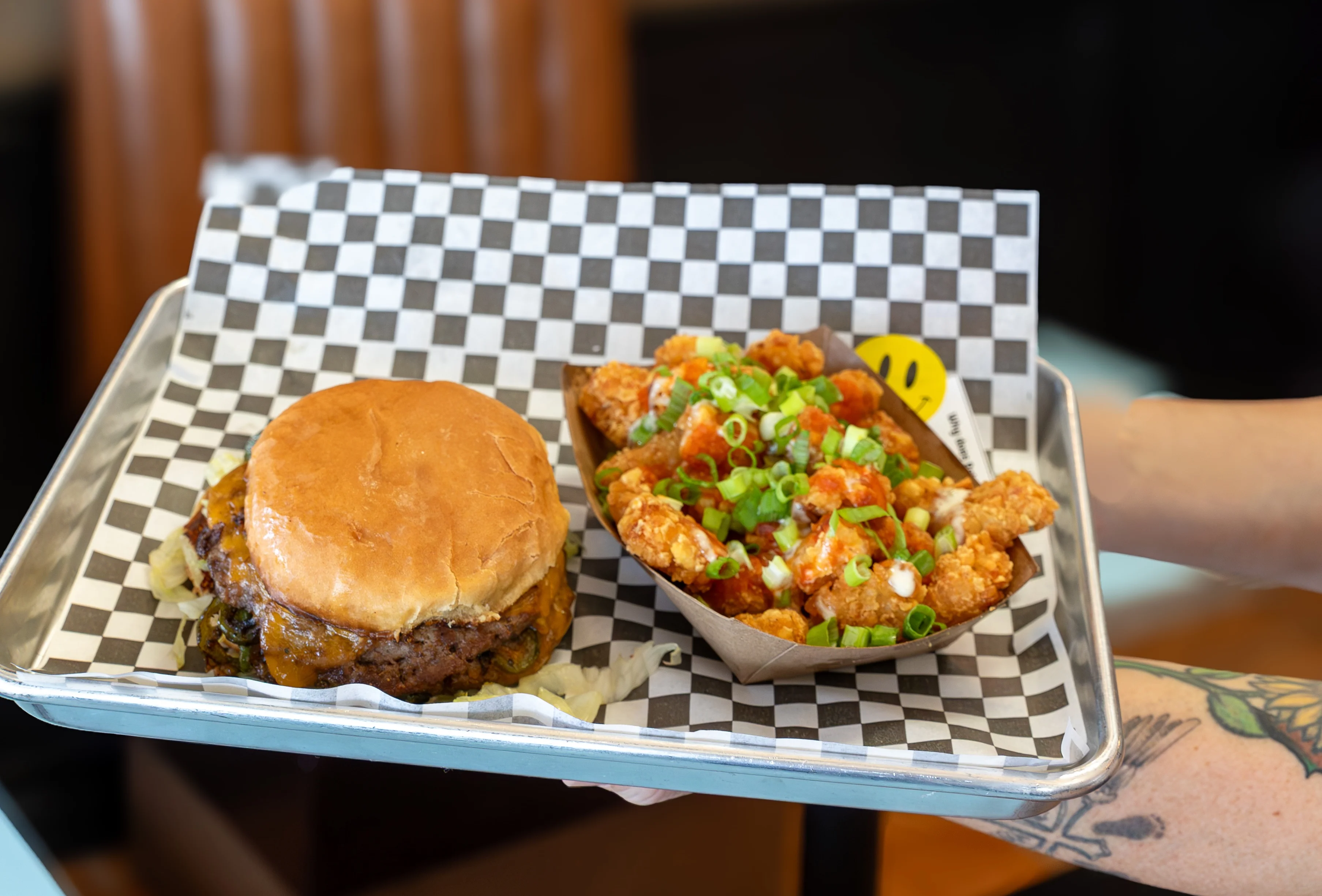 Juicy cheeseburger with loaded fries in a casual eatery