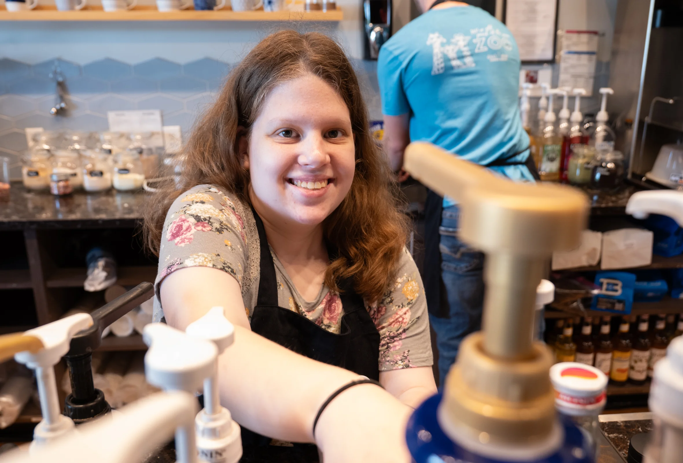 Barista visiting with a customer at a coffee shop