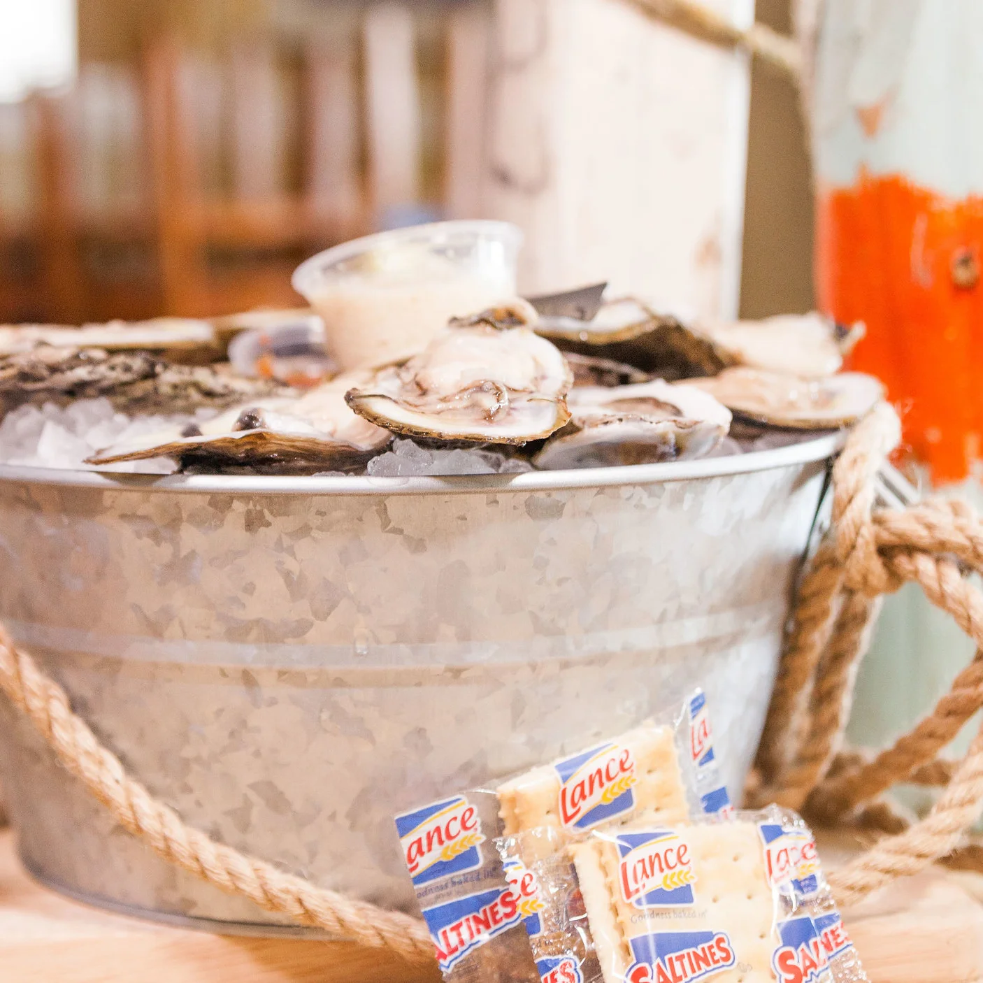 Fresh oysters on ice served in a rustic metal bucket