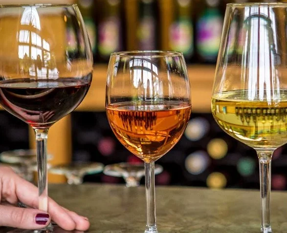 Friends toasting red wine in a bright restaurant