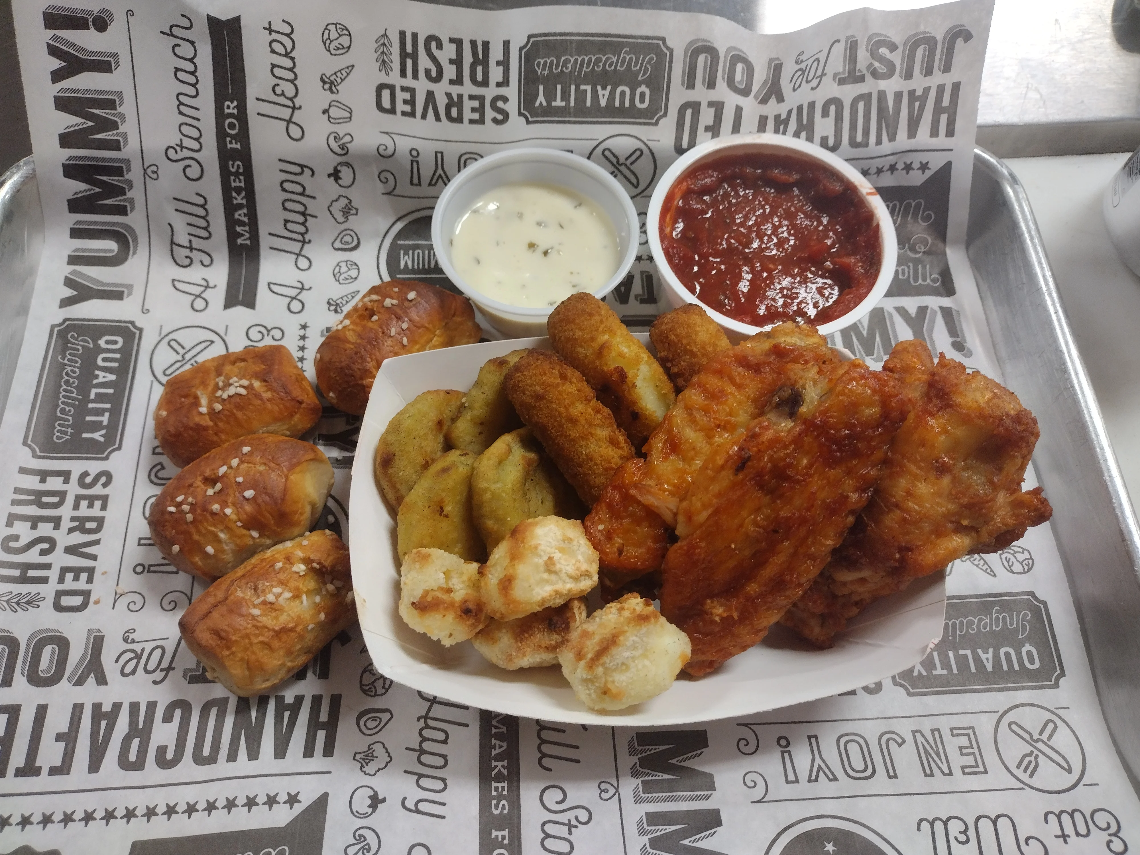American appetizer platter with wings and pretzel bites