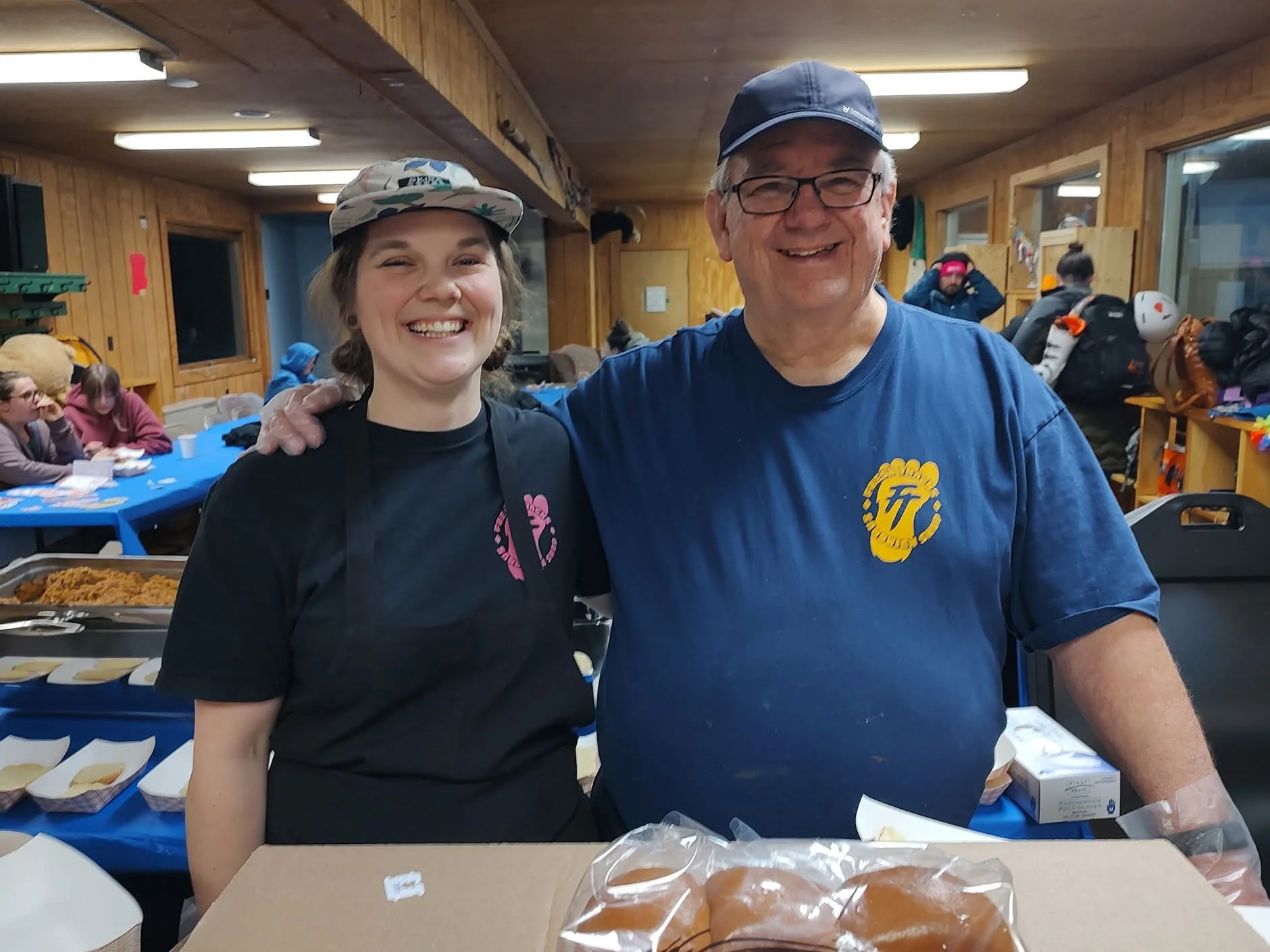 Friendly staff serving food in a cozy dining area