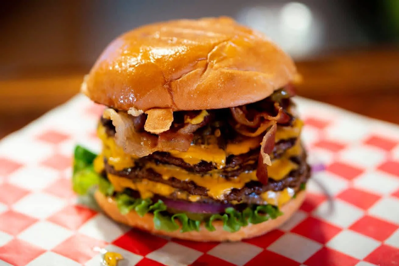 Delicious gourmet burger with fresh toppings on a wooden table