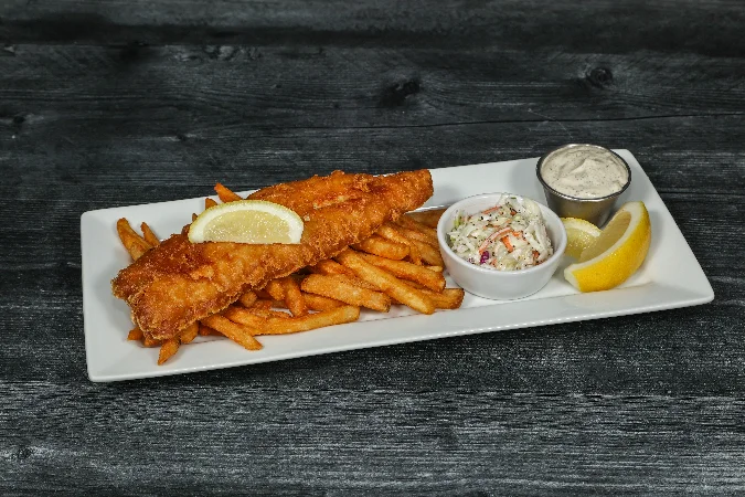 Plate of fish and chips with crispy batter and golden fries
