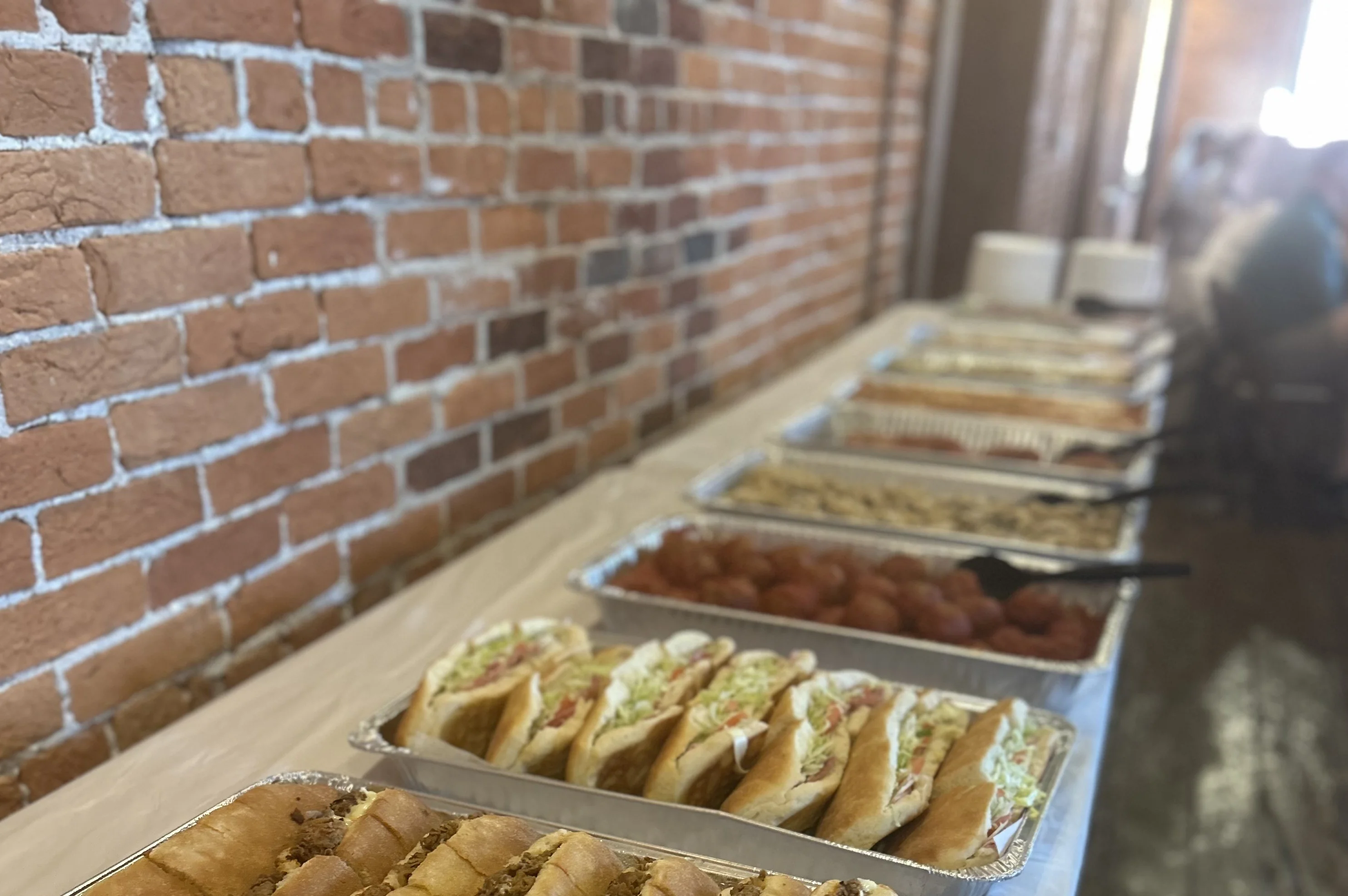 Assorted hoagies on a buffet table