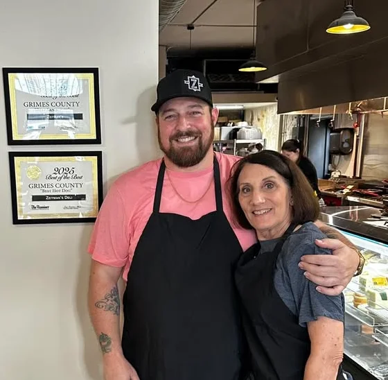 Friendly restaurant staff posing in a cozy eatery