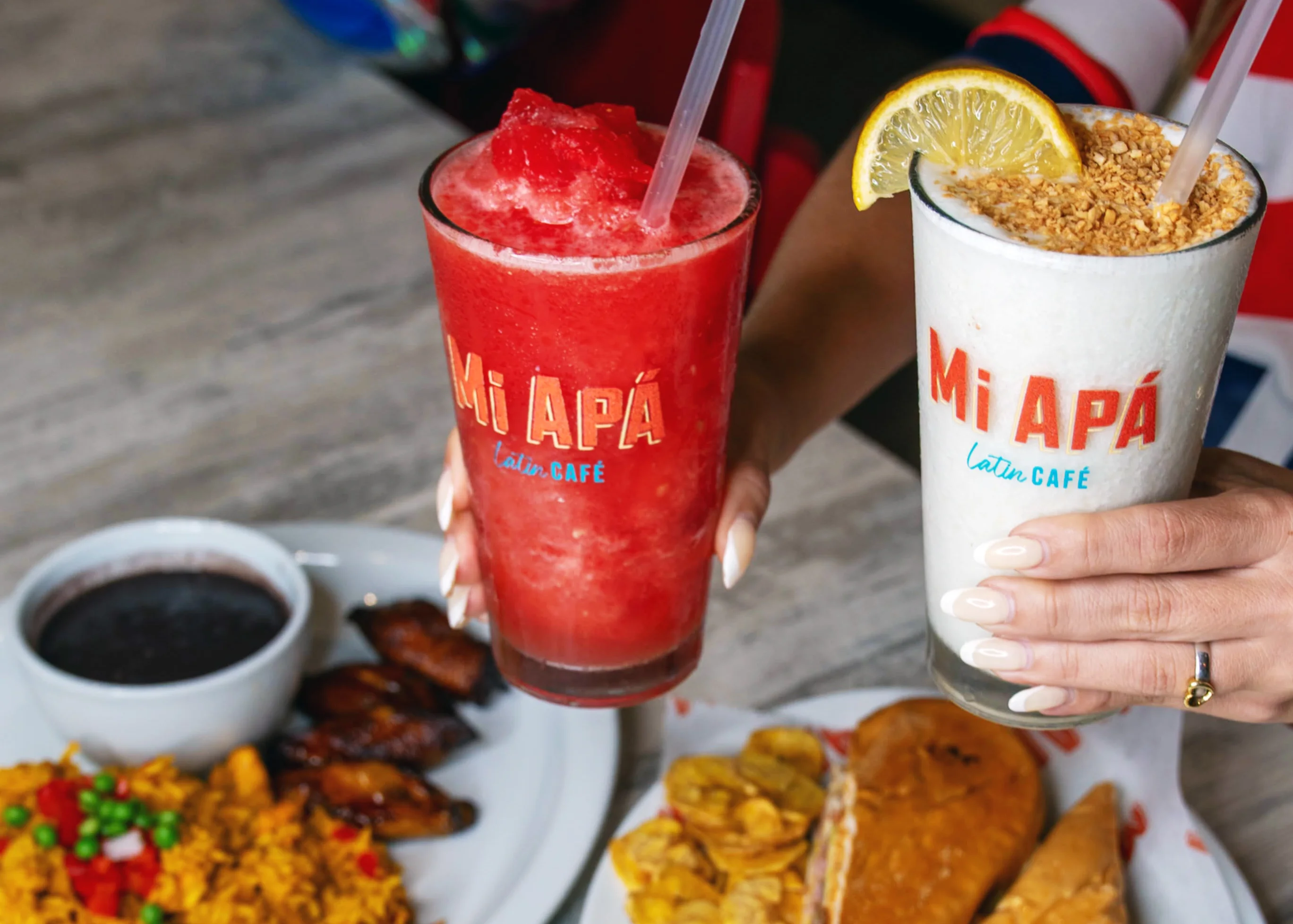Rewards Mi Apá, customers eating sandwich mango juice