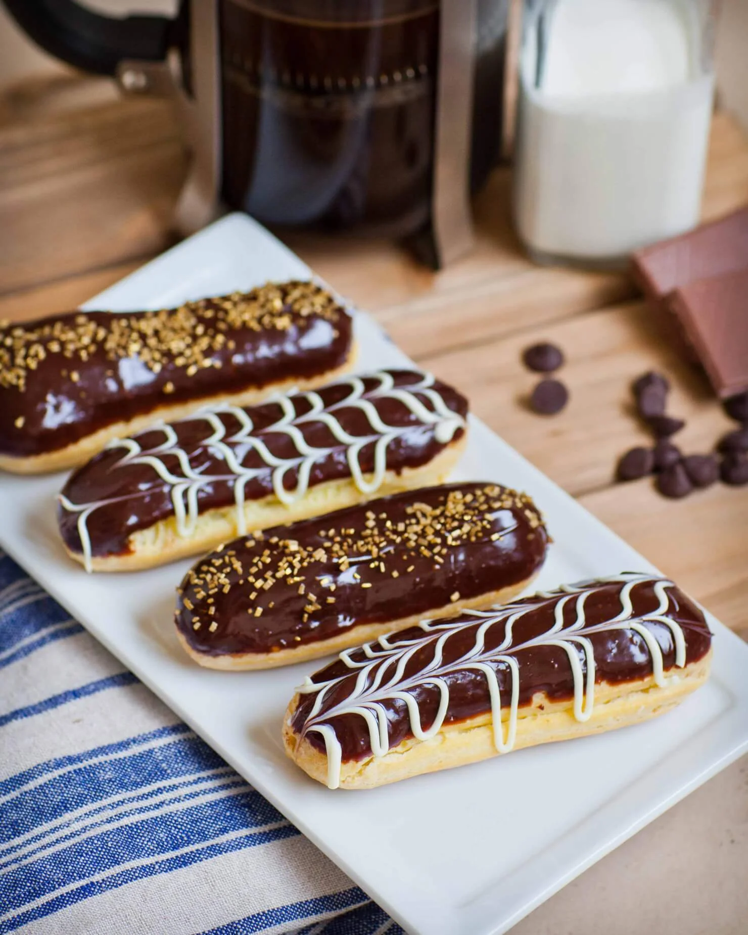 French éclairs topped with chocolate and decorative icing