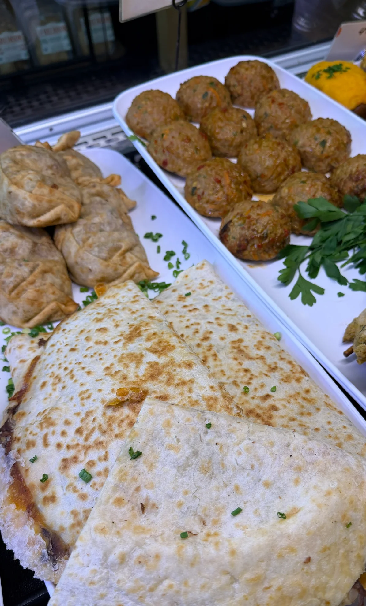 Middle Eastern platter with kofta, sambousek, grilled chicken, and flatbread