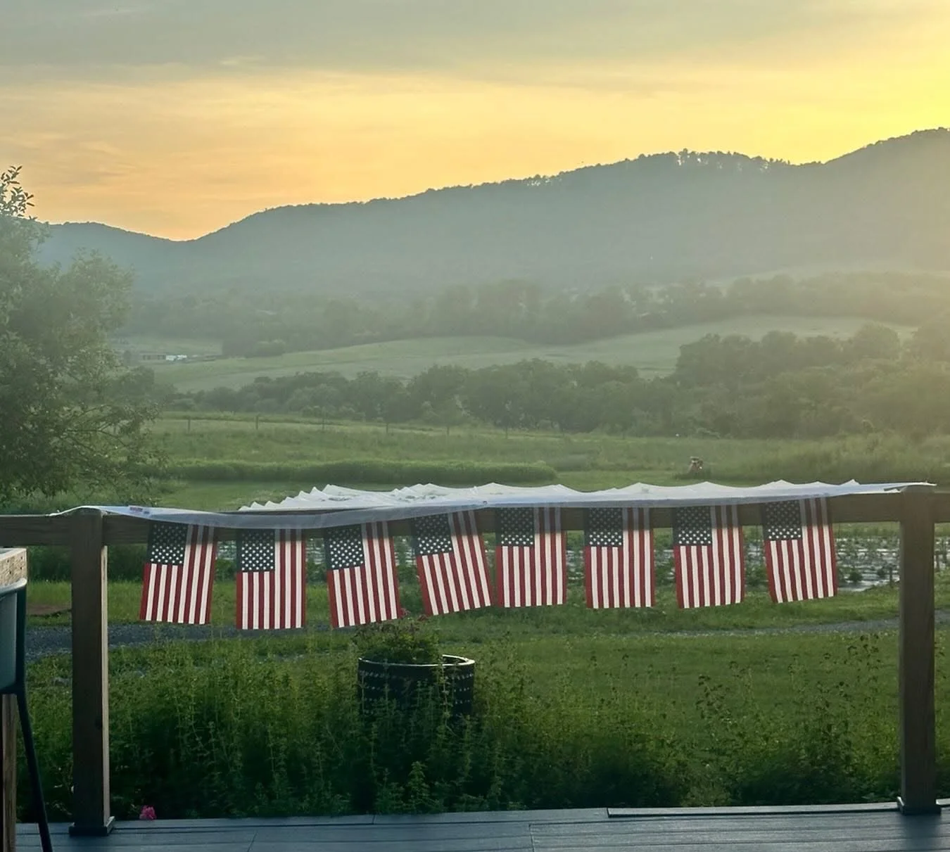 Sunset view with American flags on a porch railing
