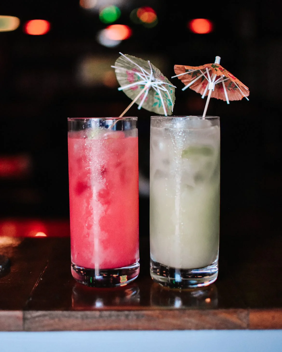 Colorful tropical cocktails with umbrellas on a bar counter