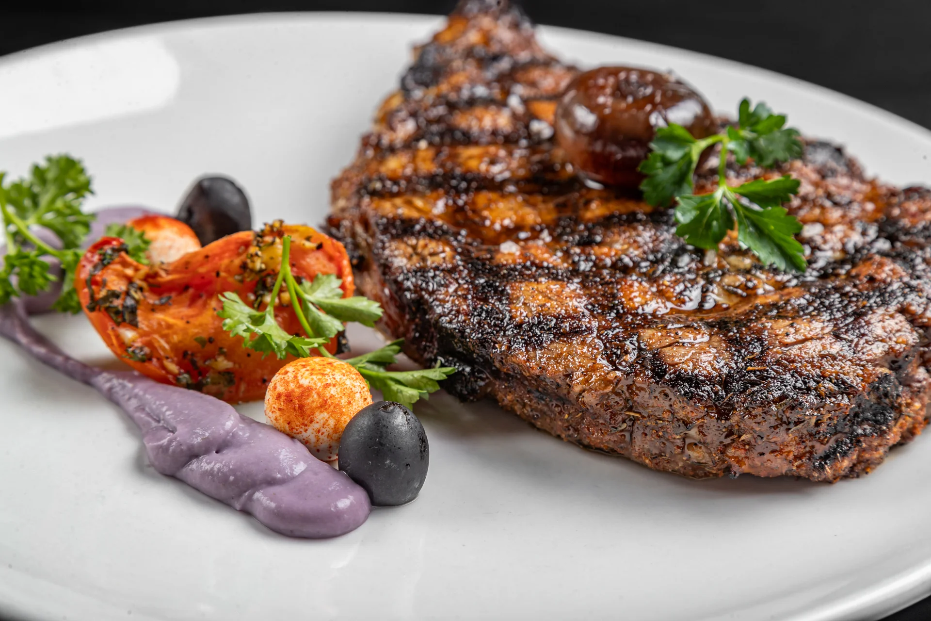 Grilled ribeye steak with vibrant sides